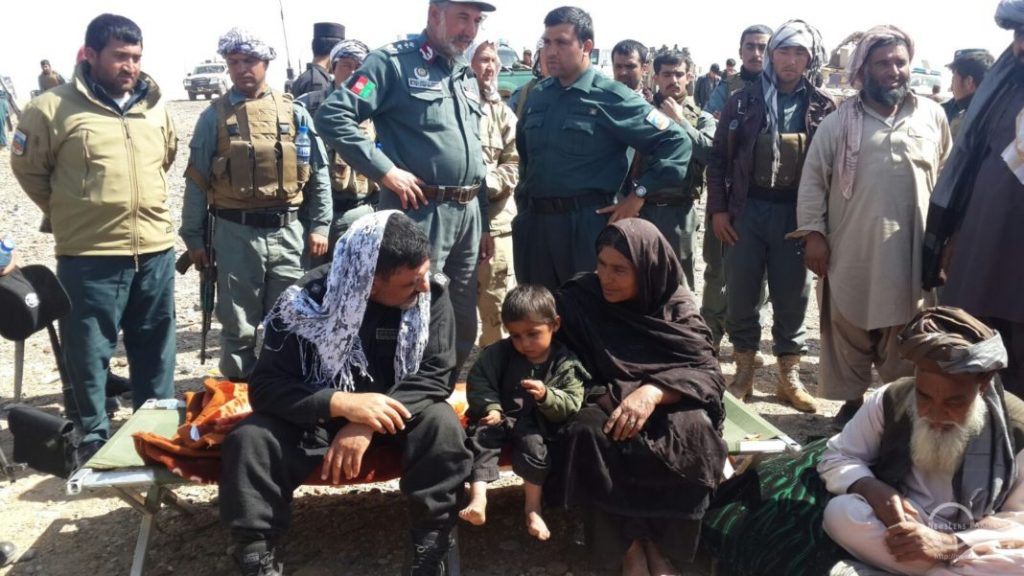 Friroza AKA Hajani shares light moments with local police officers as her grandson is seen with her in Halmand, Afghanistan : Photo By News Lens Pakistan/